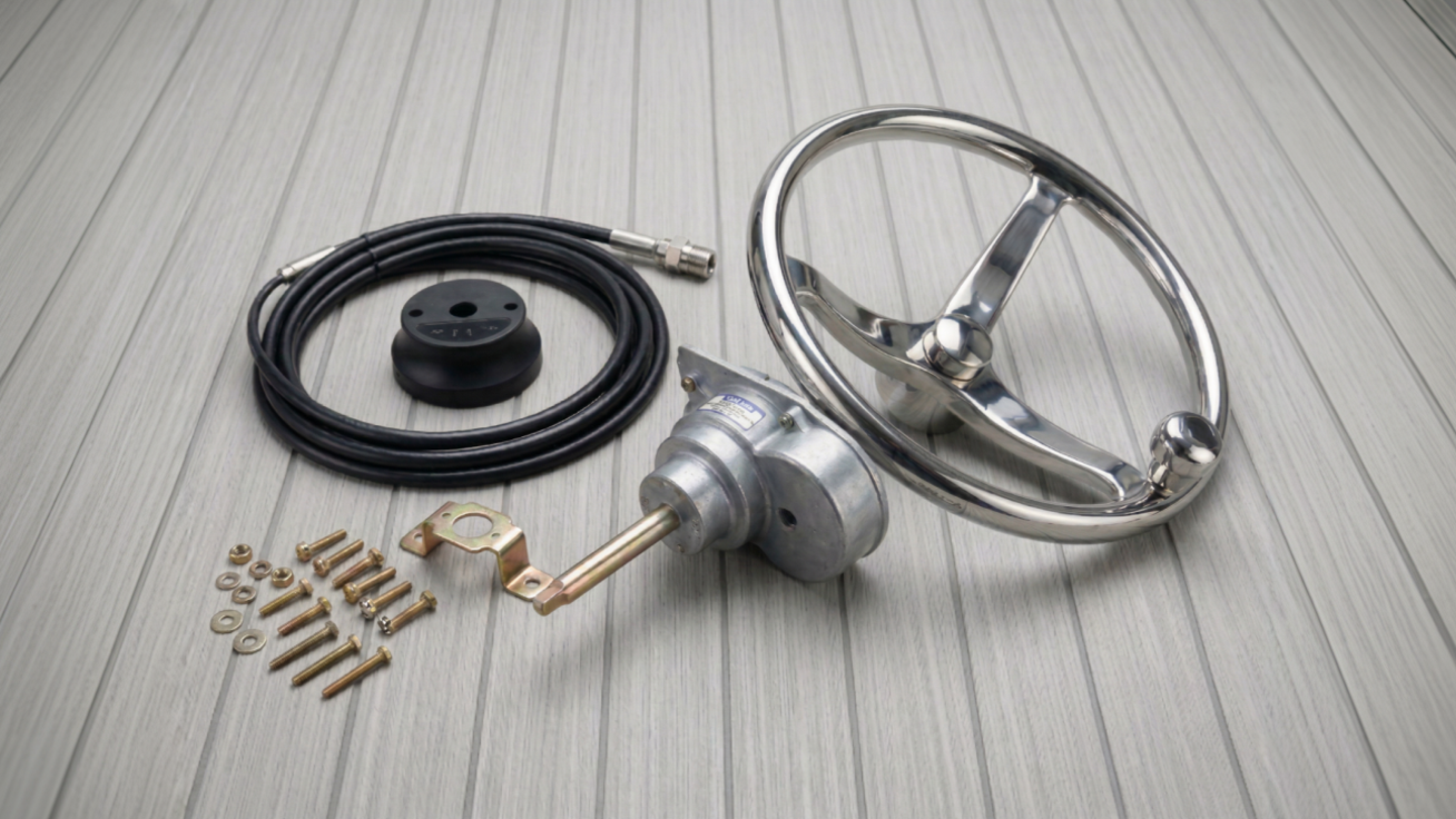 Stainless steel marine steering wheel kit with mechanical helm, cable, and mounting hardware.