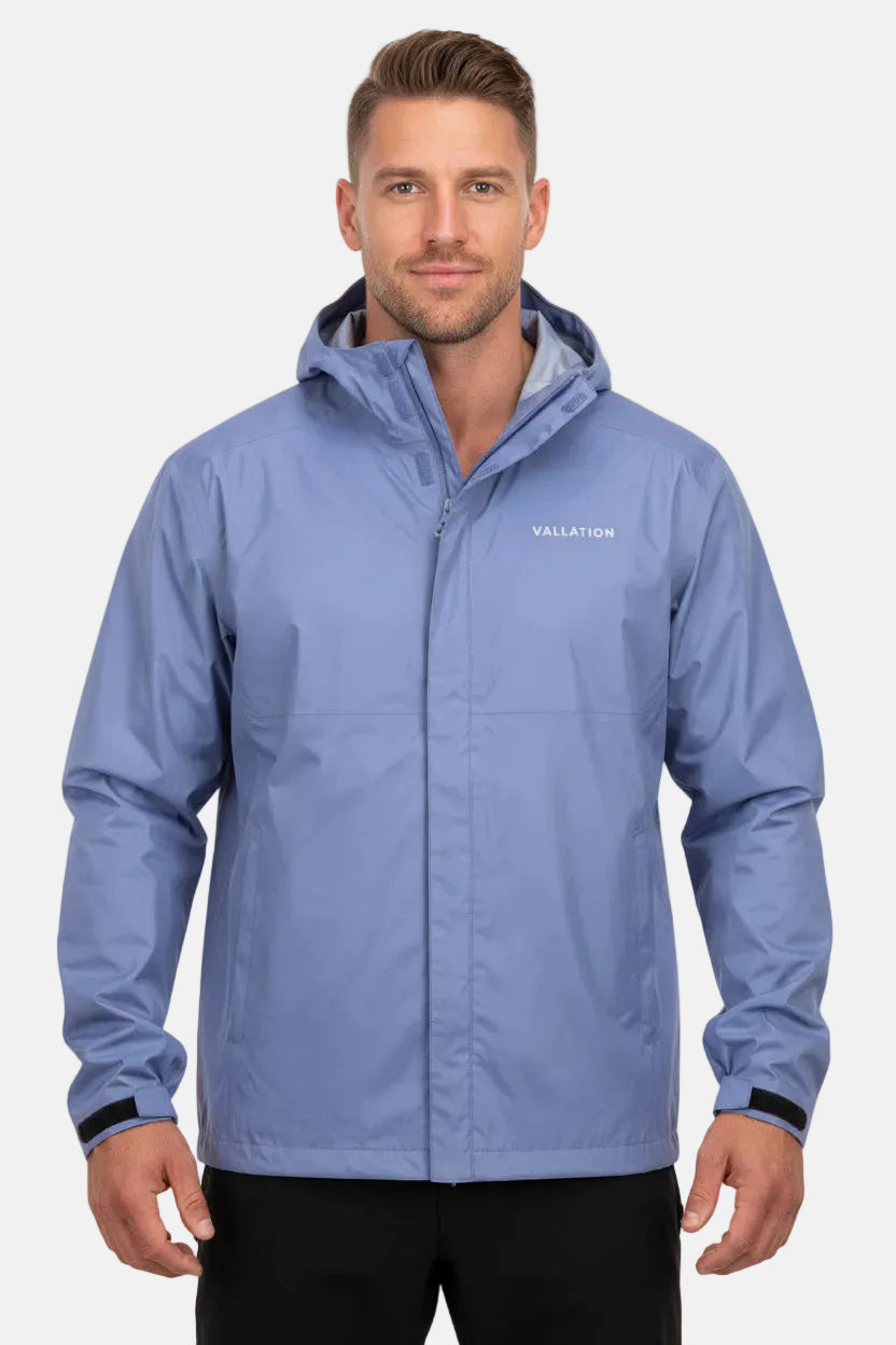 A light periwinkle blue hooded rain jacket with a dark green inner hood lining and a small white 'VALLETION' logo on the left chest, displayed on a white background.